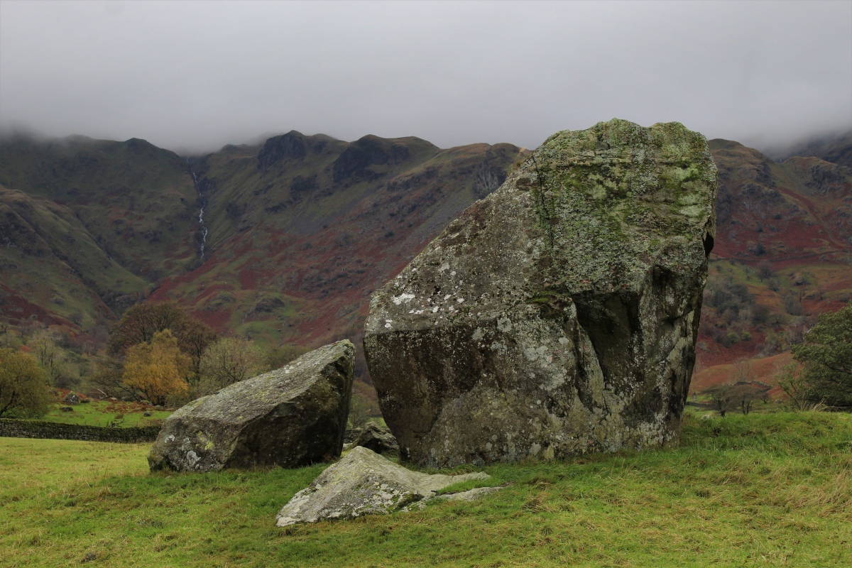 Big rocks apparently set into the end of the circular bank, and the misty lakeland fells