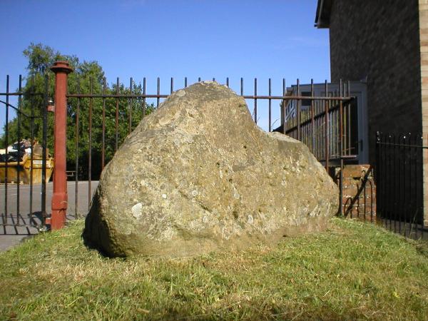 Bere Regis Sarsen. Situated just by Wool Rd, SY 847943. Lying on a small bank outside Bere Regis County School. Triangular in shape, 4.5ft x 5ft appearing limestone/quartzite. Possibly a marker.