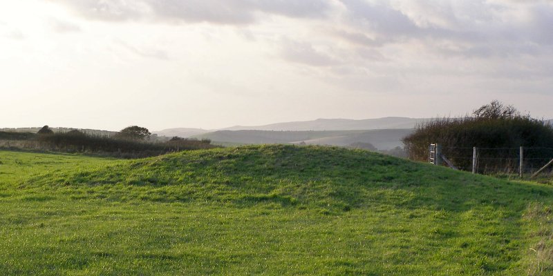 Round barrow at grid reference SY74938260. The south Dorset ridgeway is in the far distance, home to a huge number of barrows - including the Northdown cemetery. The broad hump in the haze, left of centre, is Chalbury hillfort.