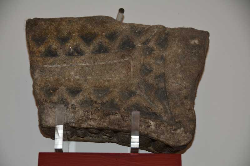 This is a fragment of cross arm and cross head dating from the first half of the 8th century.  Corpus of Anglo Saxon Sculpture reference: Jarrow 08 and 09.