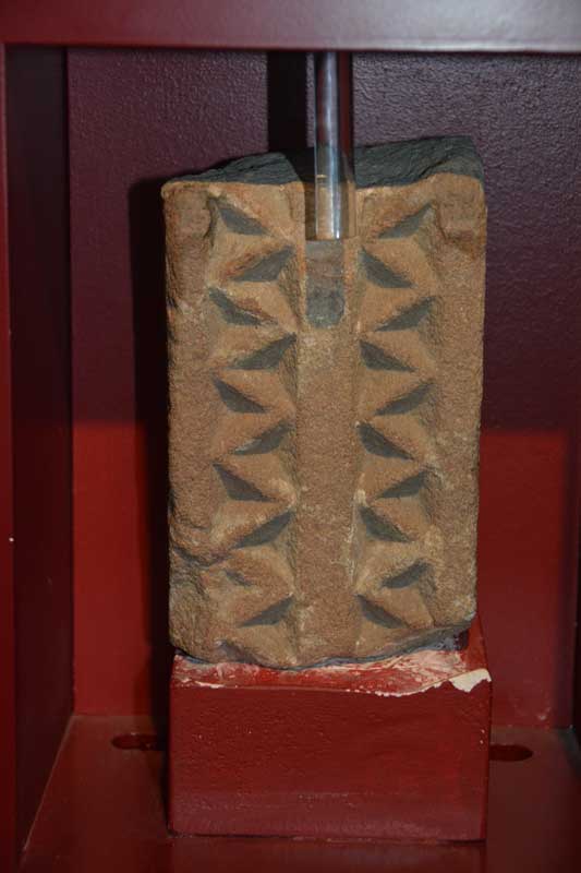 This is a fragment of cross arm and cross head dating from the first half of the 8th century.  Corpus of Anglo Saxon Sculpture reference: Jarrow 08 and 09.