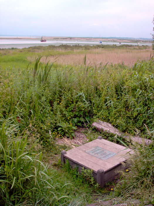 Just off the Coast Road near West Mersea on Mersea Island, the well is well signposted and reached by a short footpath on board-walks across the marshes.  Over protected by safety conscious bureaucrats - there is nothing to see but a wooden box and a bronze plate!  Great location though.