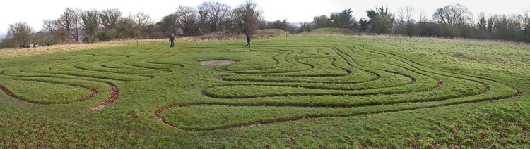 January 2005. Composite image. The information board at the site says that the maze is unlikely to have existed before the 17th century. Behind the maze, the original entrance to the St Catherine's Hill hillfort is visible as a gap in the ramparts.