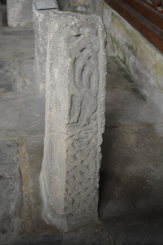 This is eastern face of the tallest of the three crosses in the south-east chapel, containing interlacing surmounted by a truncated (possibly animal) figure.  