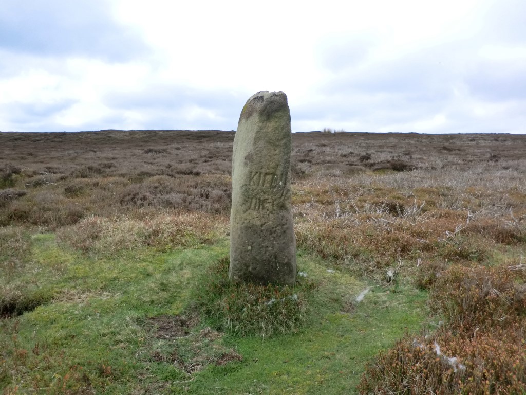 Guide Stone at SE 61204 95435  - East Face, April 2014. Hayes in his 1988 publication “Old Roads and Pannierways in North East Yorkshire” page 41 says this inscription reads ‘This Kirby Road’ (Kirkbymoorside). The only word I can make out clearly is Kirby.  