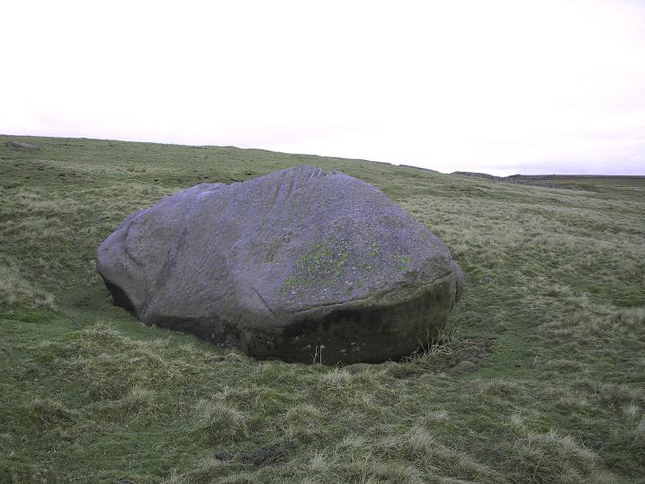 Skyreholme, Burhill Ridge SE0840362226

This large rock sits on Burhill Ridge, a couple of hundred meters north of cup markings in Burhill Kiln Allotment. The top of the stone has some cup like marks & grooves on it, but whether they’re natural or not, couldn’t be decided by Paul Bennett, Graeme Chappell, or myself.

Far more interestingly is what lies on the underside of the south edge, P
