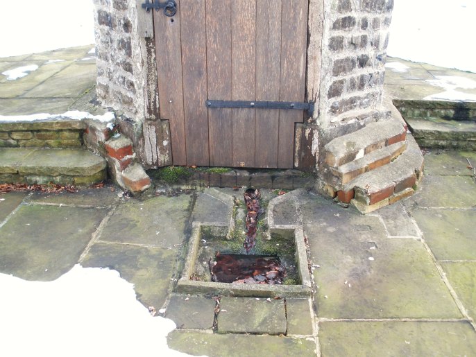 Church Well or St Mary's Well at Thornton-in-Craven, N.Yorks. A close-up view showing the outside square-shaped basin. Photo taken on 09.12.10.
