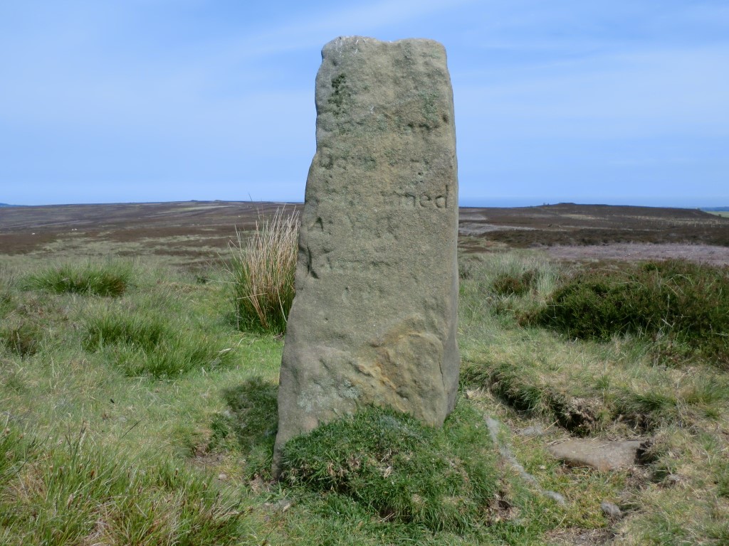 Breckon Howe at NZ 85376 03406 – South face of boundary stone, June 2012. Suffering from erosion the inscription reads ‘Goathland boundary determined at York Assizes 1813’ over six lines.