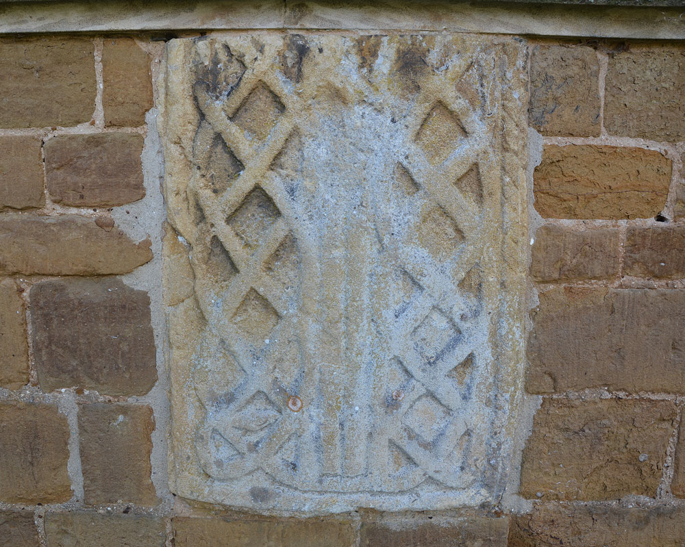 Ancient cross in Leicestershire and Rutland England. This is the fragment of Anglo Saxon stone embedded in the exterior east wall of the church, immediately underneath the east window. Prof. Rosemary Cramp in her paper 