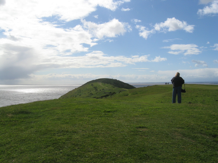 On the summit of Brean Down (like a dragon's back) standing by the barrow near the temple, looking along the spine towards the head.