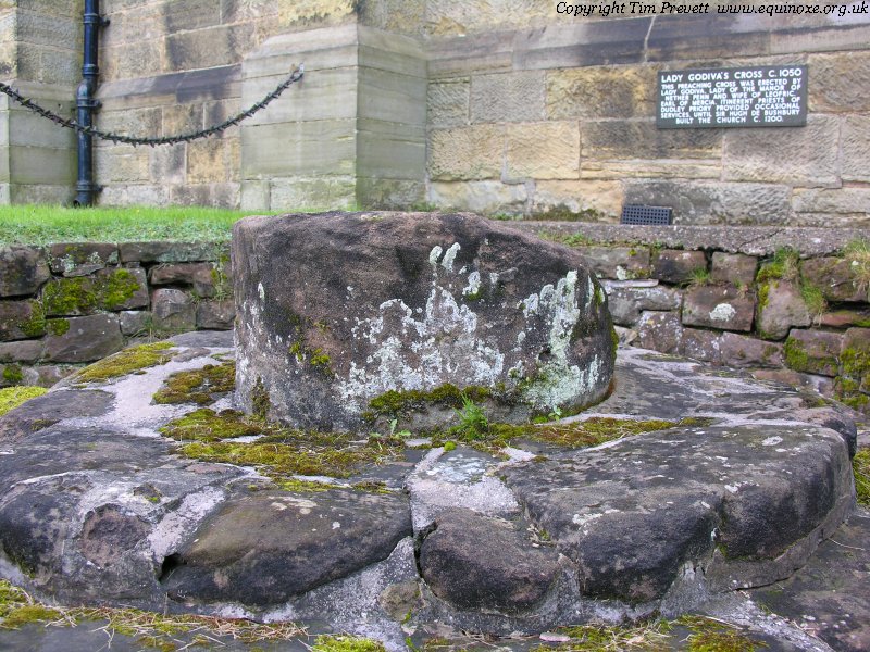 The remains of the cross shaft, with steps dating to around 1050, attributed to the instruction of Lady Godiva. This is on the south side of the church. The relatively more recent cross base and even later cross at the western end of the churchyard were originally on top of Godiva's Cross, and their maintenance yielded the discovery of the earlier cross base and partial shaft beneath.