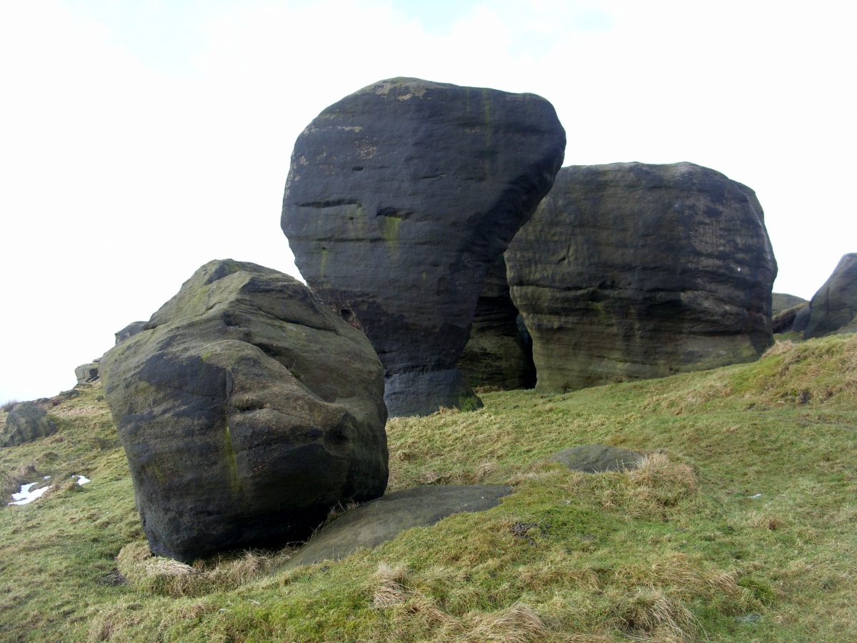The broken Groom Stone (left) and Bride Stone (central) in The Bridestones (Todmorden).