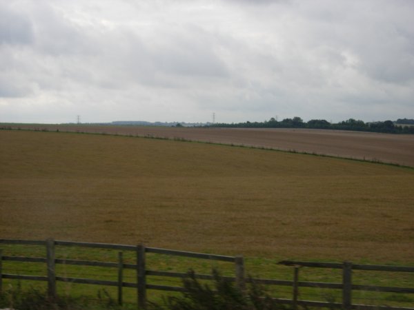The site of the perished Coneybury henge (second field in); a forgotten contemporary of the first phase of Stonehenge. Taken on top of a double decker bus going past!