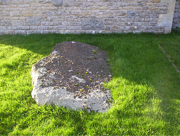 Inside the church yard by the wall of the church. This may have been from a local destroyed Long Barrow. 