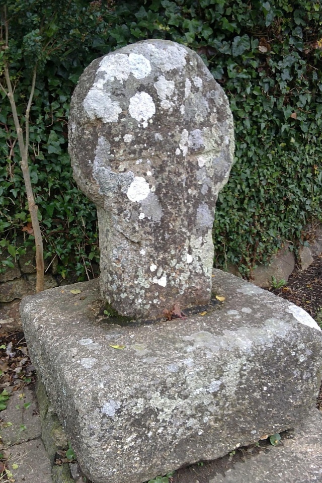 The medieval wayside cross, in its base, was found circa 1878 buried in the hedge opposite its present location, 100 yards southeast of the church.