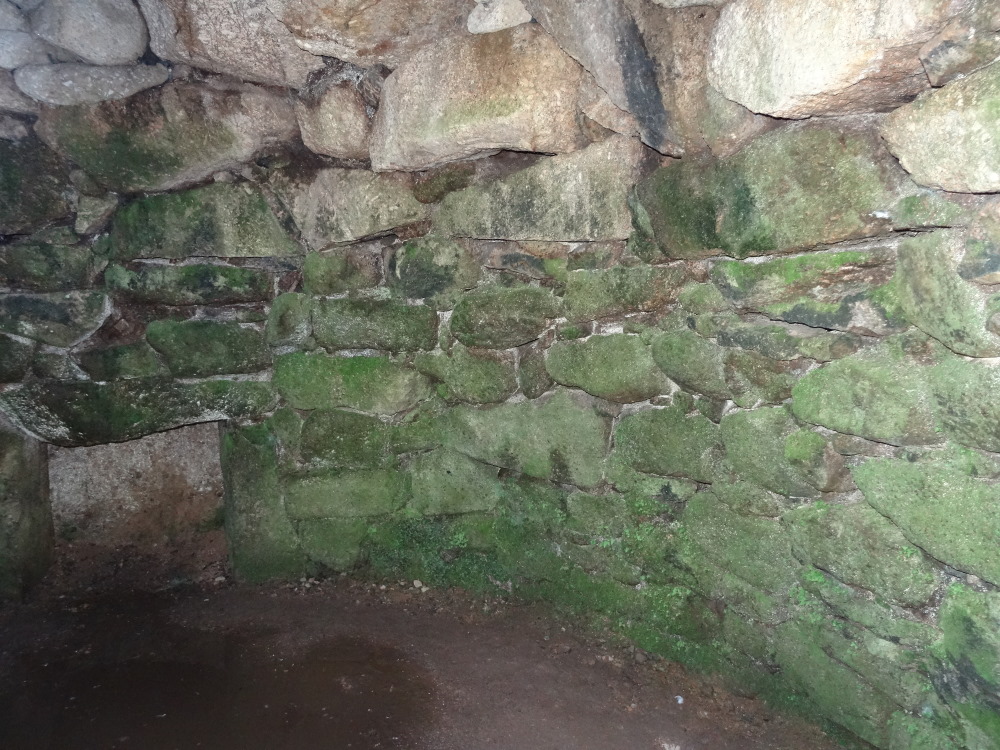 Moving around the corbelled chamber anticlockwise from the entrance passage, showing the wall to the right [WNW?] of the 'hearth' or recess.