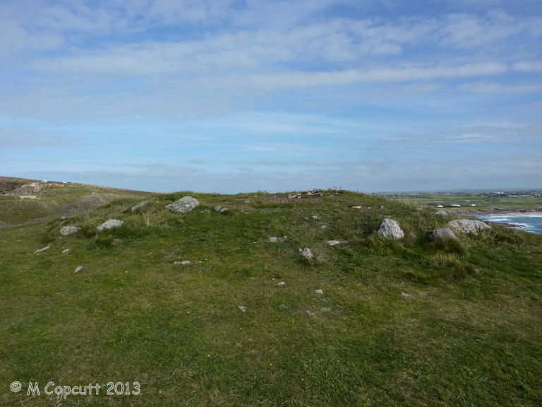 Right on the top of the headland is the remains of what is described as Tumulus. The mound is about 8 metres diameter, still more than one metre in height, and largely composed of white quartzy looking rock. 