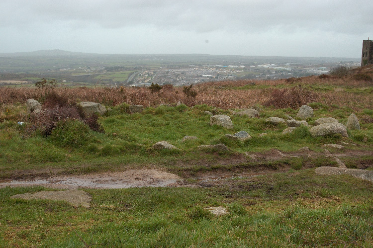 One of the hut circles at the Carn Brea settlement.  Looking over to the Pool and Redruth conurbation.

SW685407; 50.220896N, 5.246674W