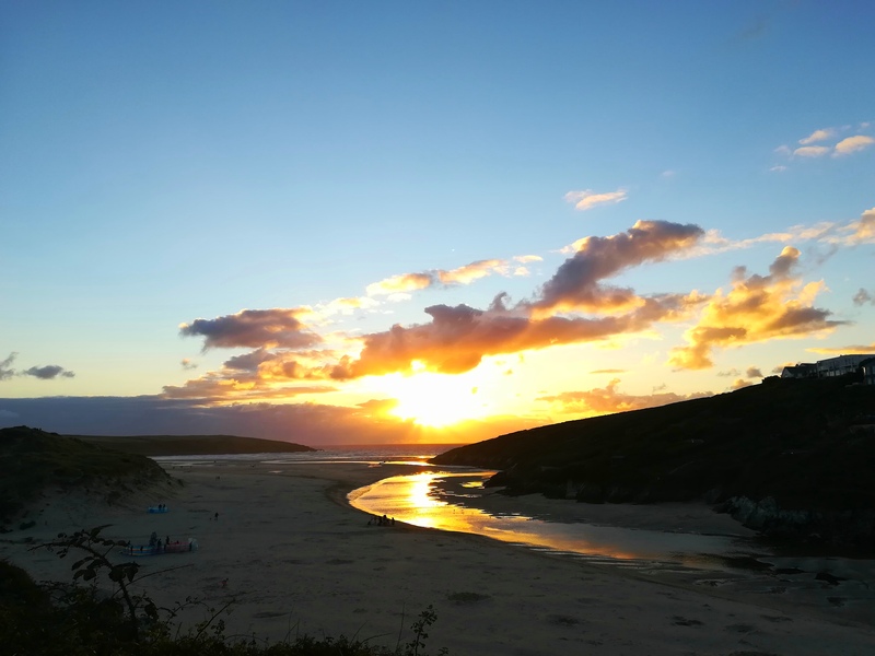 Sunset over Crantock Beach with the Pentire headland (The Warren) with it's barrows rising on the right