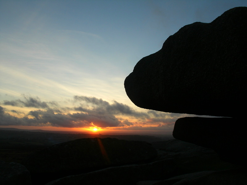 An outcrop at the Western end of Carn Brea fort and a winter sunset.