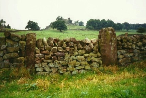 A circle stone in the wall at Nine Stones Close.