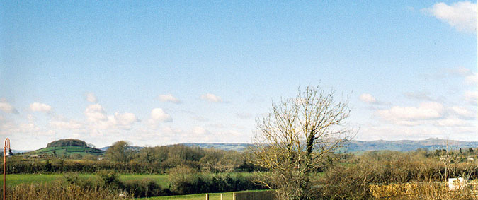 Denbury Fort (left) from Fermoys Garden Centre, looking towards approximately WNW.  To the far right (just to E of N) is Haytor, at 457m one of the most prominent tors on the SE of Dartmoor
