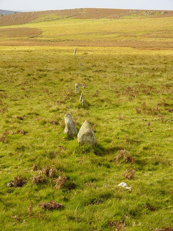 The NW stone row at Drizzlecombe begins at the center cairn (of a 3-cairn group oriented SE just downhill the settlement) and is aligned at 235º.