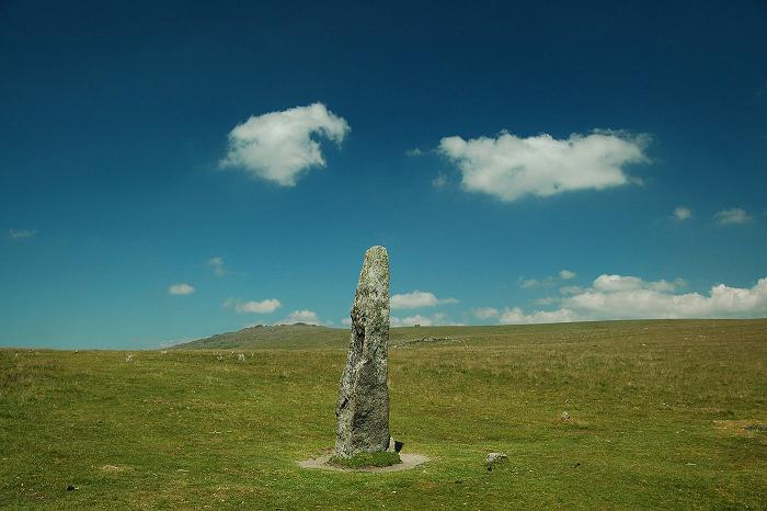 Standing stone with the small stones of the circle just behind and to the left, Great Mis Tor in the distance, facing north-east