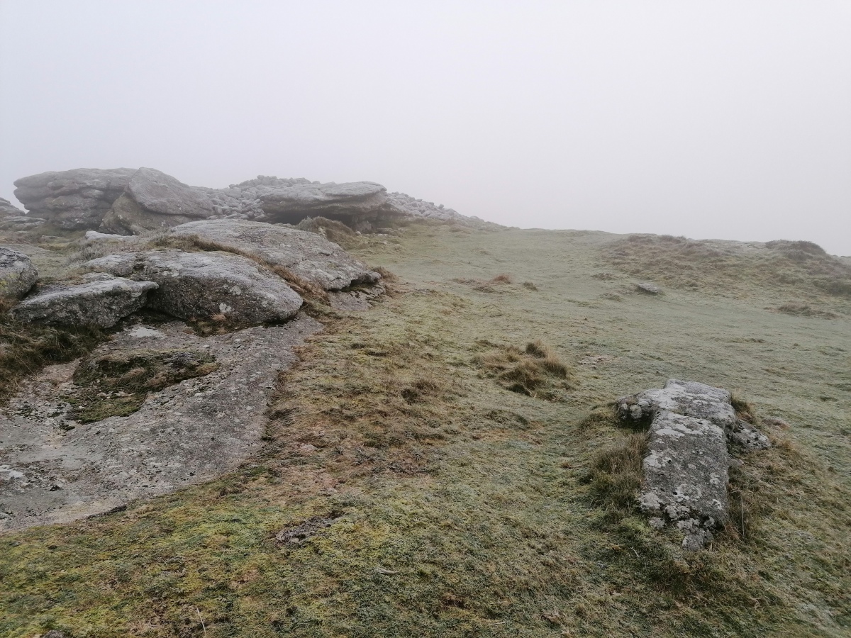 The partly cut cross in its position about 20m west of the main tor cairn and trigpoint