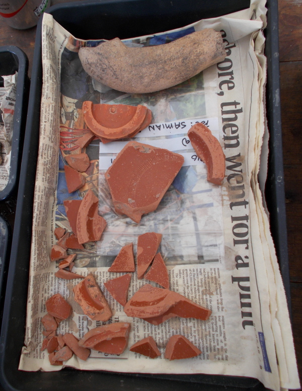 A broken Samian Ware bowl and what looks like part of a handle from another amphora.. ?
