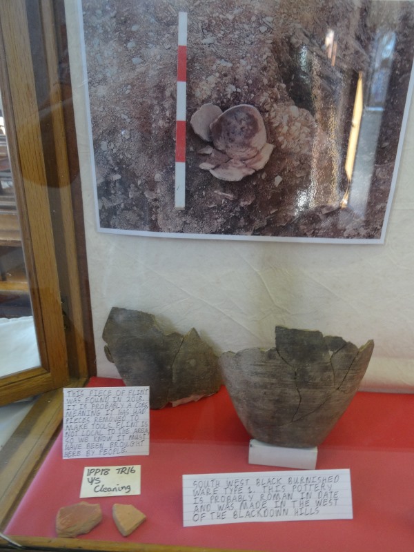 South West Black Burnished Ware and a piece of flint, with some pottery on display at the Methodist chapel.