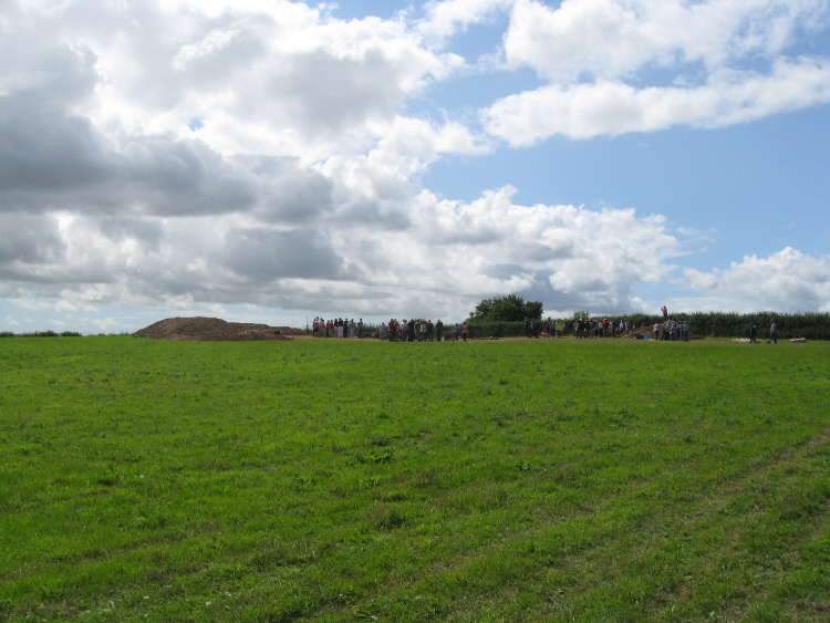 Walking up-slope towards the area of excavation in this field near Ipplepen, on 18th August 2013.