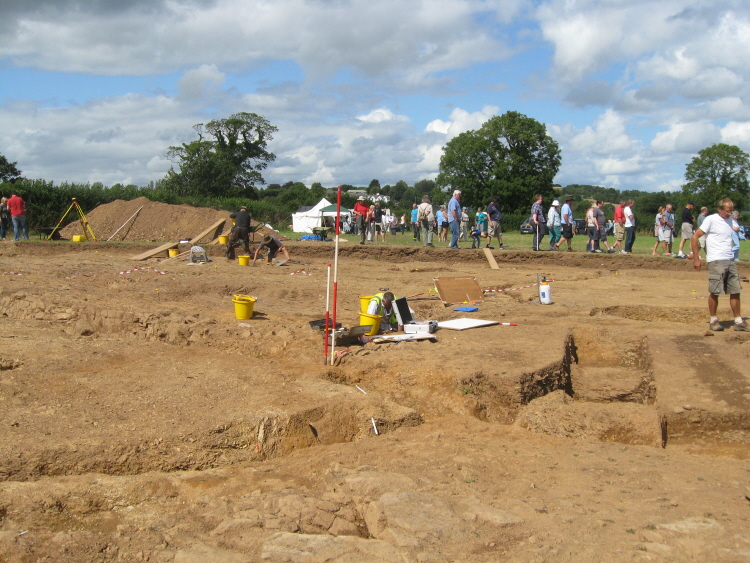 This view looking NW-N shows the remainder of the arc, running N - S, of the large ring ditch.  The soil heap in the distance was a handy perch for a photographer recording the excavations.