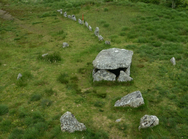 View from above and west showing the row leading towards the kerbed cairn with cist (Scale 1m). 