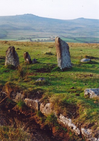 About 5.30pm on 10th October 2007, looking NW towards Great Staple Tor [L] and Roos Tor [R], and showing the blocking stone at the east of the north row.  (The two stones to its left are the beginning of the long row.) 
In the foreground is the narrow granite-lined leat which separates the two main rows.