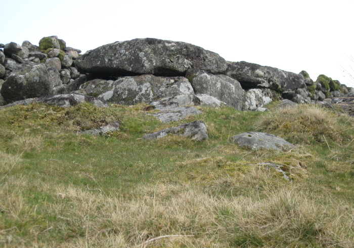 Looking up to the north side of the cairn and cist from a low level.