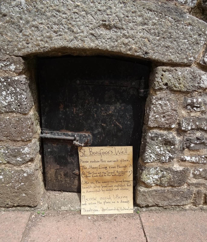 A notice regarding ley lines propped up against St Boniface's Well last July (2017). 