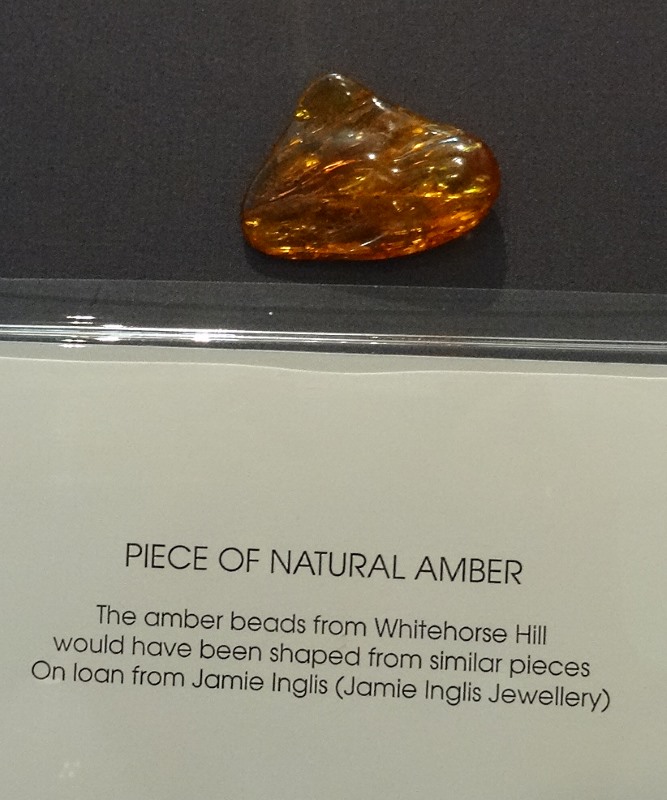 A beautiful lump of amber from which seven beads were fashioned and deposited in the cist.  