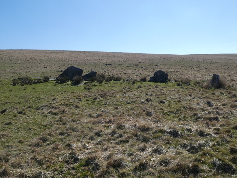 Most of what is left is at the uphill side, large slabs set on their long sides and a couple of standing stones forming an arc, indicating a diameter of about 25 metres. 