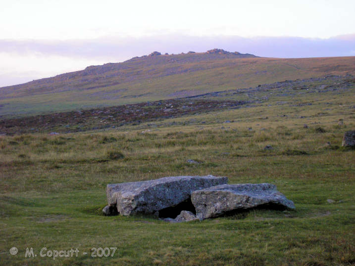 The large cist at Merrivale seen in the dying light of an August day. 
Great Staple Tor still has some golden sunlight on its upper parts in the background. 

