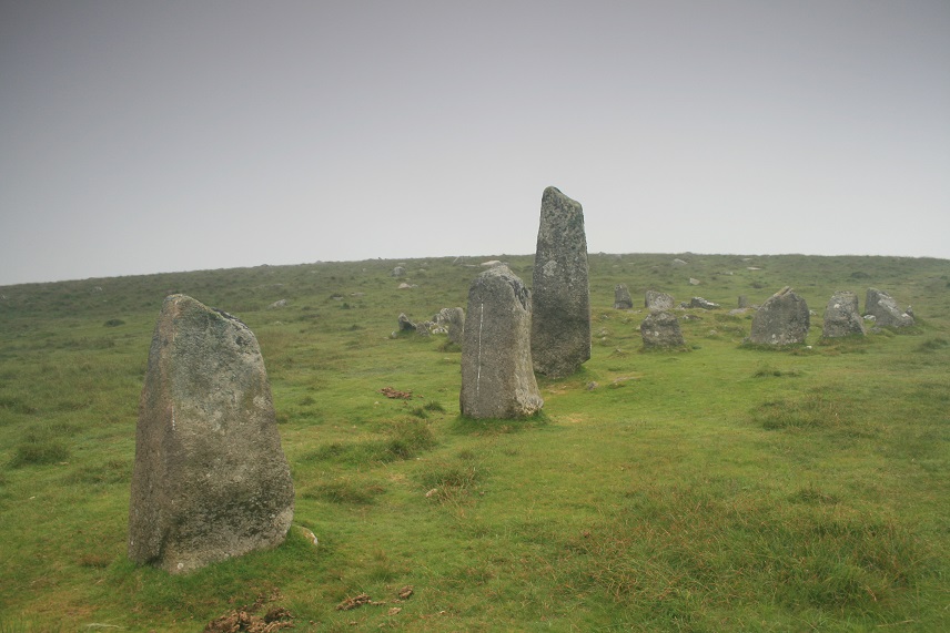 The tall stone next to the circle was re-set deeper than the original stone hole, ie: it was taller in prehistory.