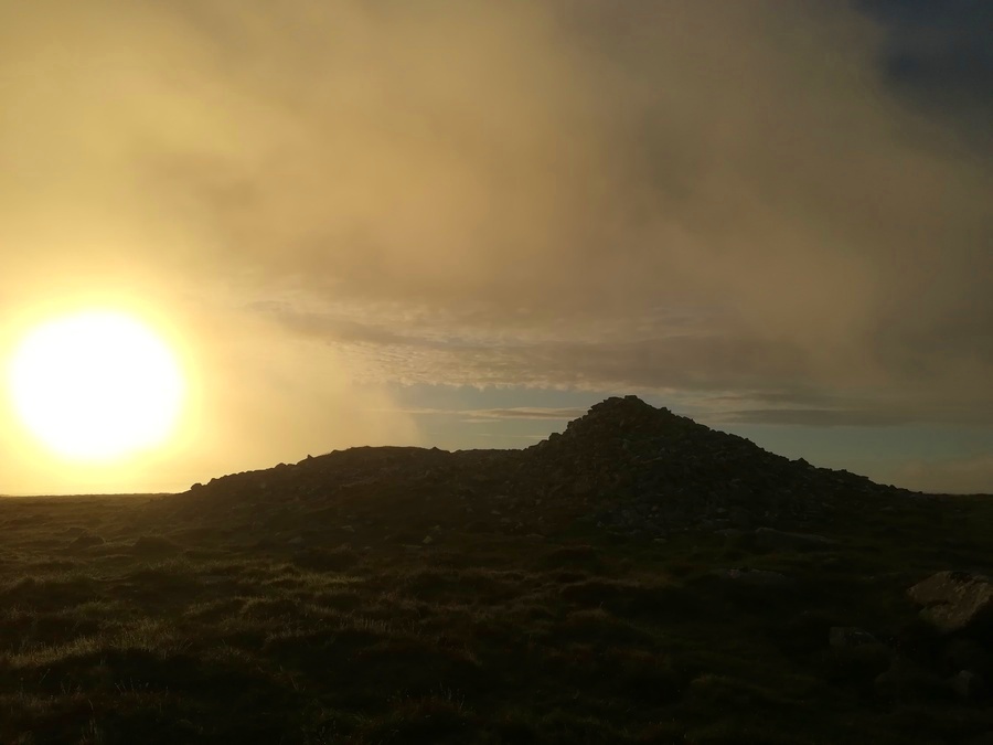 Cosdon Hill Summit Cairn and a misty June morning Sun
