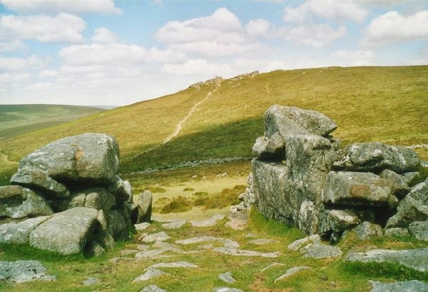 Though the entrance of Grimspound and over the site towards Hookney Tor.