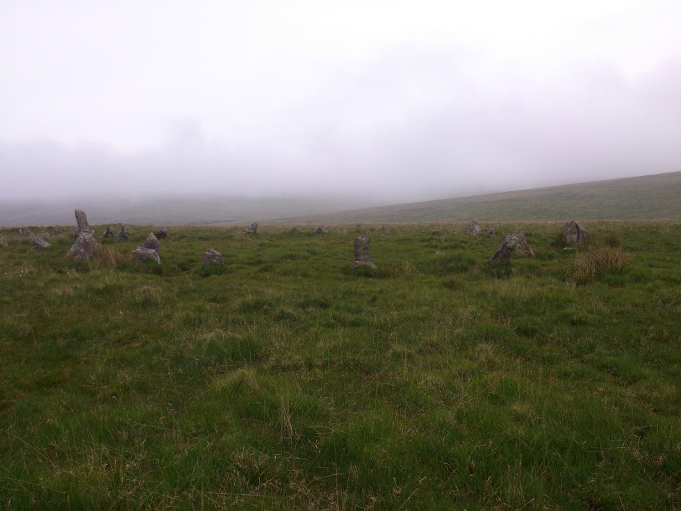This Stone Row is part of the longest stone row in Europe, and this entry refers to the northern part of the row. It is considered by some that the row was originally two rows, the northern and southern ends, which over time became joined together. 

Just the occasional stone can be followed from the top of Green Hill, and its remains of a cairn near to the summit at 473 metres altitude. It has 