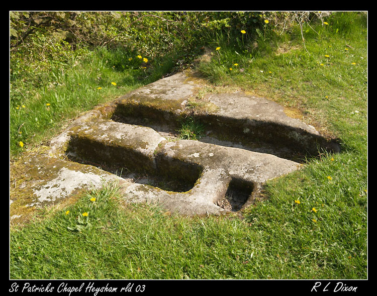 What looks like two smaller rock cut tombs next to the Chapel  of St. Patrick at Heysham. 
24/4/2011