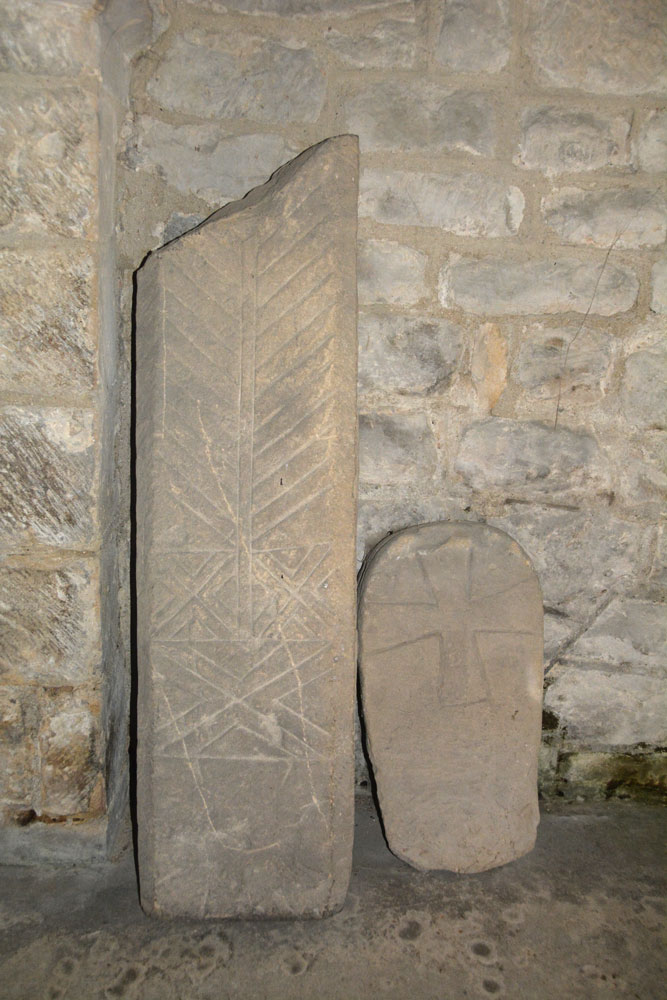 AS Corpus Bolam 01 (right) and 02, both propped against the south wall of the tower, inside.  Both date from the eleventh century.