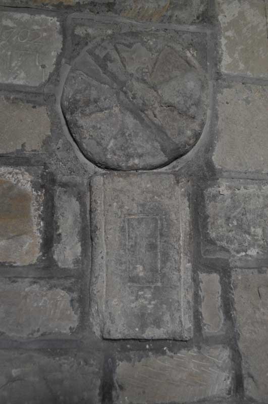 An undated Saxon cross-shaft fragment and circular grave marker/dedication cross from the second half of the 11th century are built into the northern wall of the nave near the font.