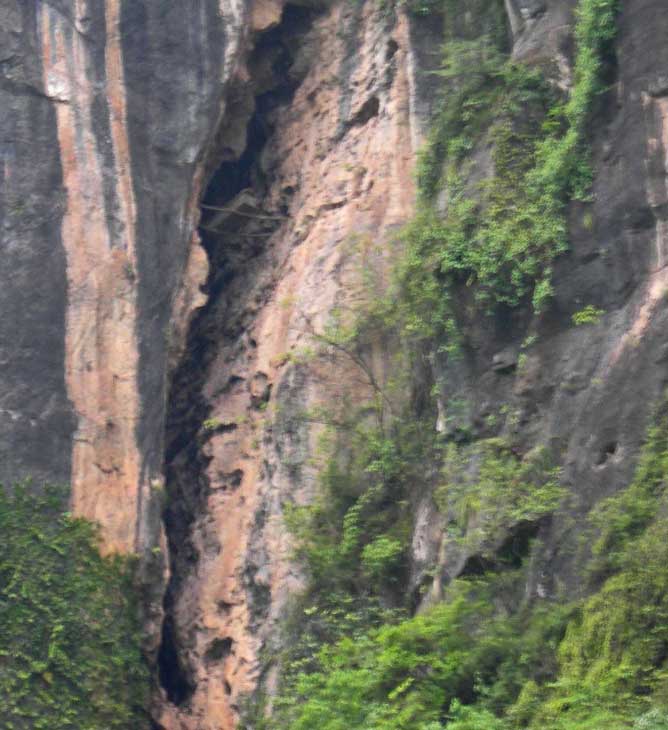 Undisturbed hanging coffin high on cliffs of the Shen Nong Gorge.  This ancient specimen is supported on two transverse wooden poles and will survive the ultimate inundation of the Three Gorges Dam project.