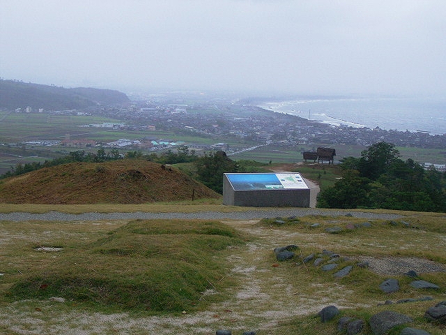 Site in Honshu Japan: The guiding panel, the reconstructed residences and the raging waves.