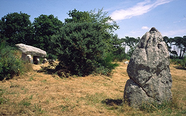 2.3m high menhir with dolmen in the background.
